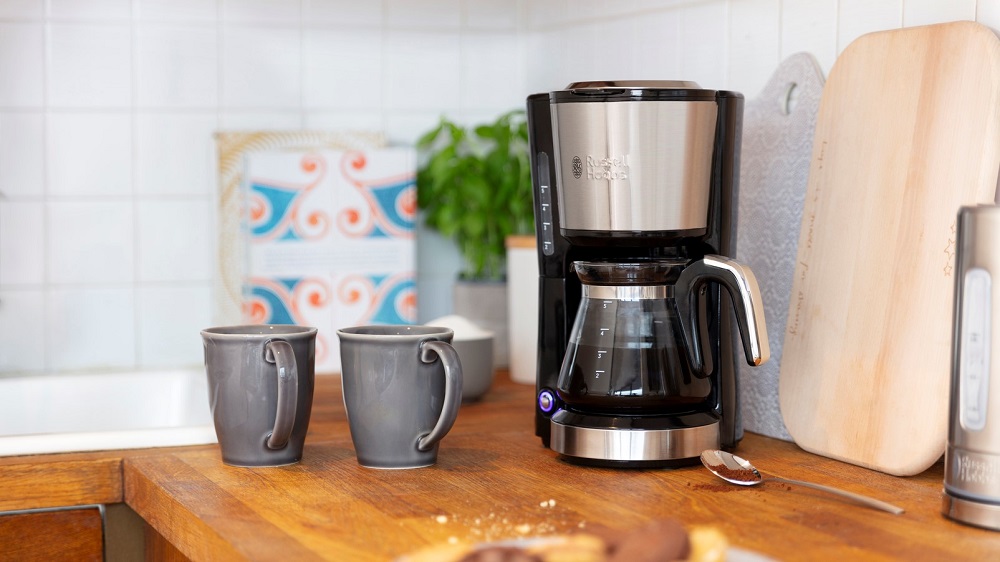 Häppchen: Kaffeemaschine steht auf der Küchenzeile. Daneben zwei Tassen.