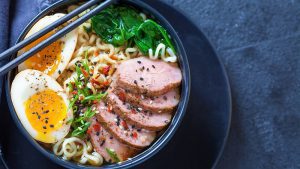 Japanese ramen noodle soup with duck breast, egg, chives and spinach