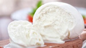 Büffelmozzarella, angeschnitten auf Holzbrett